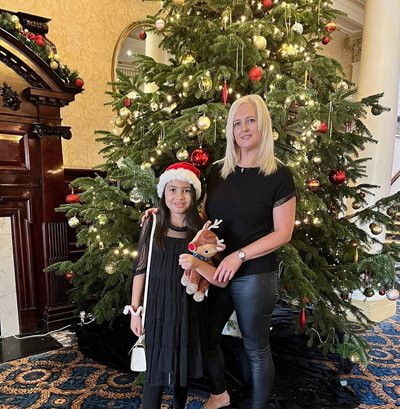 Mother and Daughter stood by Christmas Tree at the Imperial Hotel